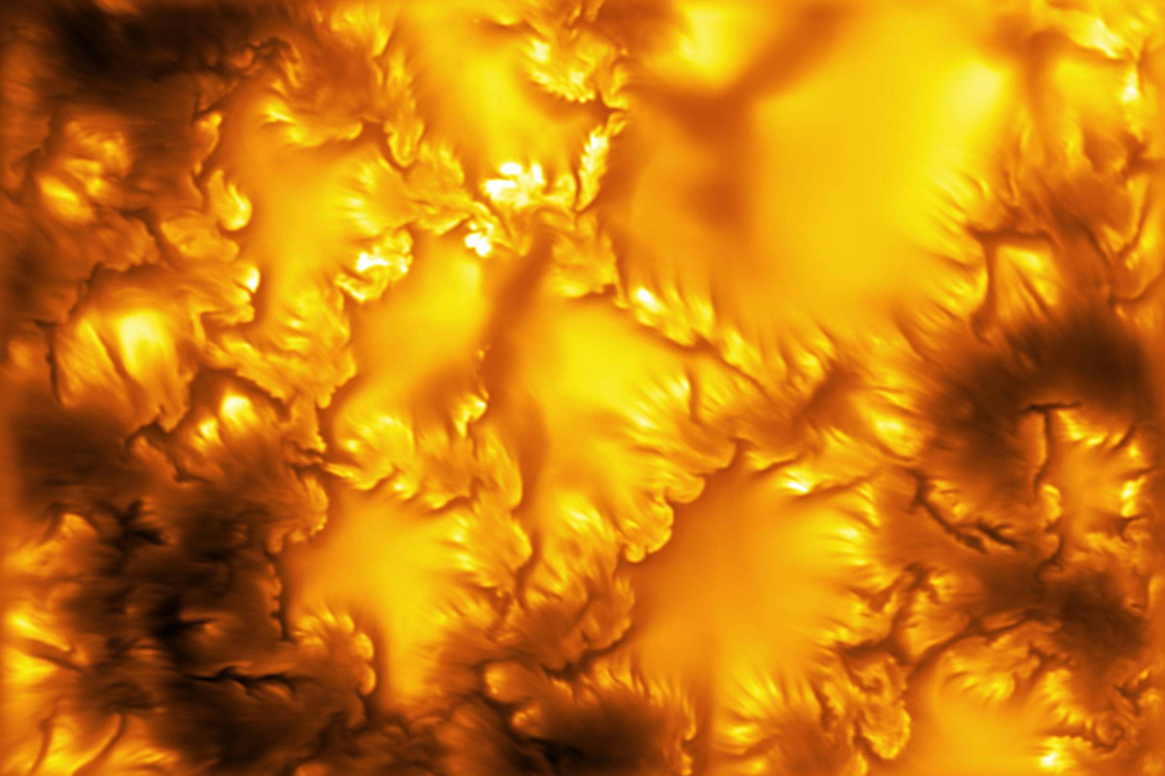 Imagem mostra uma textura abstrata com padrões irregulares em tons dourados brilhantes e áreas escuras em preto, criando efeito de relevo e profundidade.