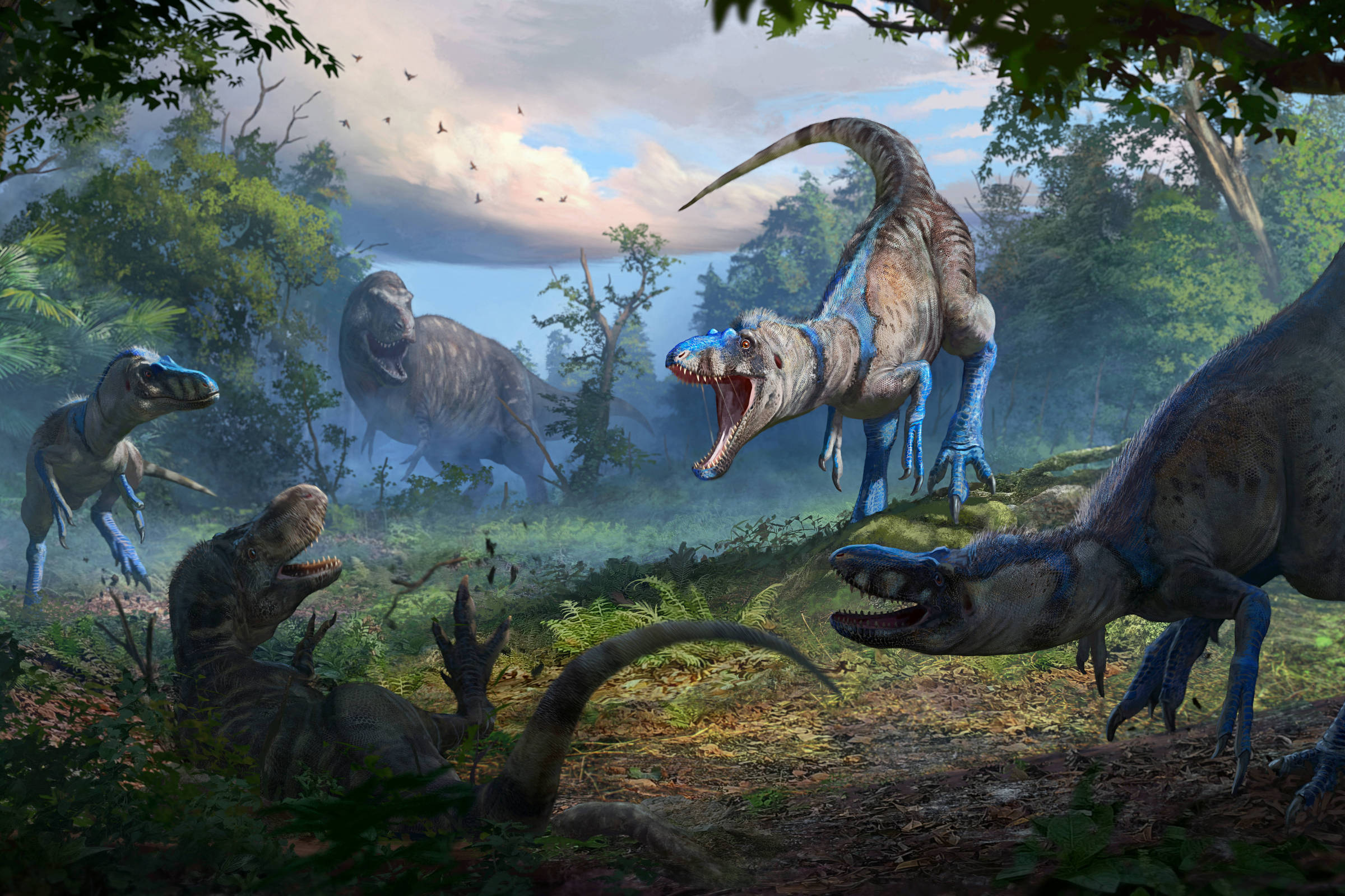Cinco dinossauros carnívoros em uma floresta densa com vegetação exuberante. Um dinossauro no centro ruge com a boca aberta, enquanto outros estão em diferentes posturas ao redor, incluindo um deitado no chão. O céu está parcialmente nublado com luz suave iluminando a cena.